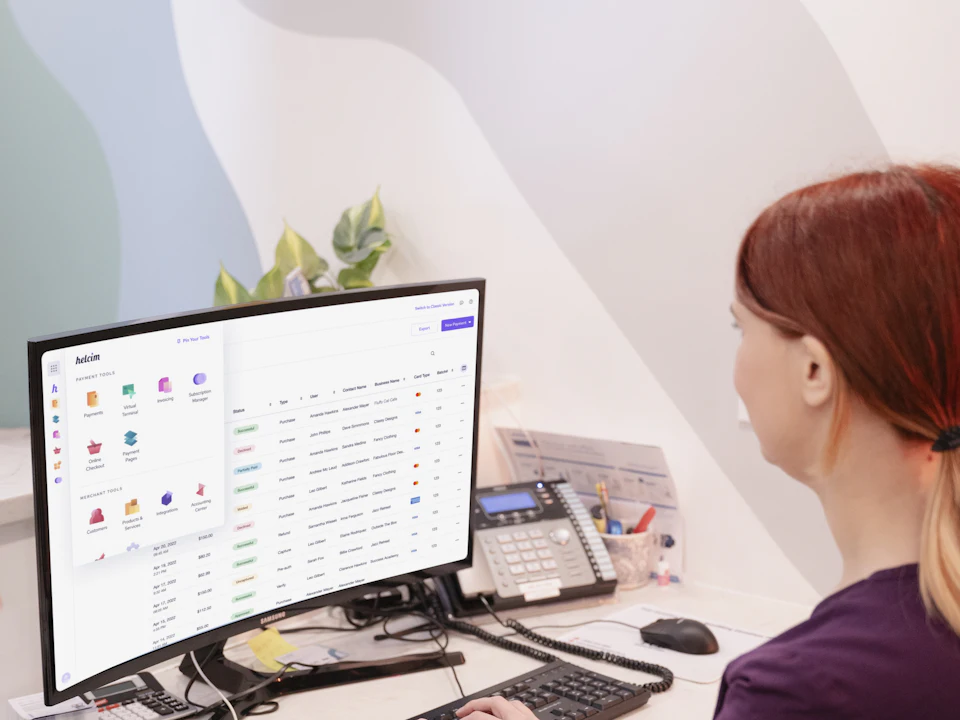 A front desk team member working at a computer